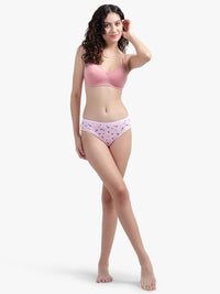 Woman wearing a pink bra and panties set on a white background