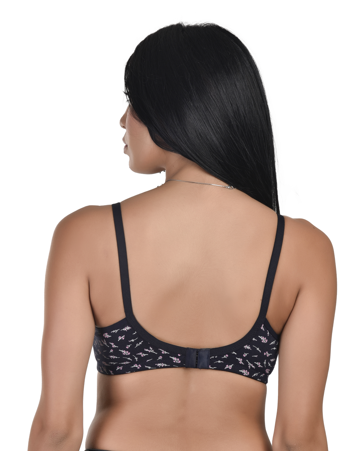 Woman wearing a black bra with floral patterns on a white background