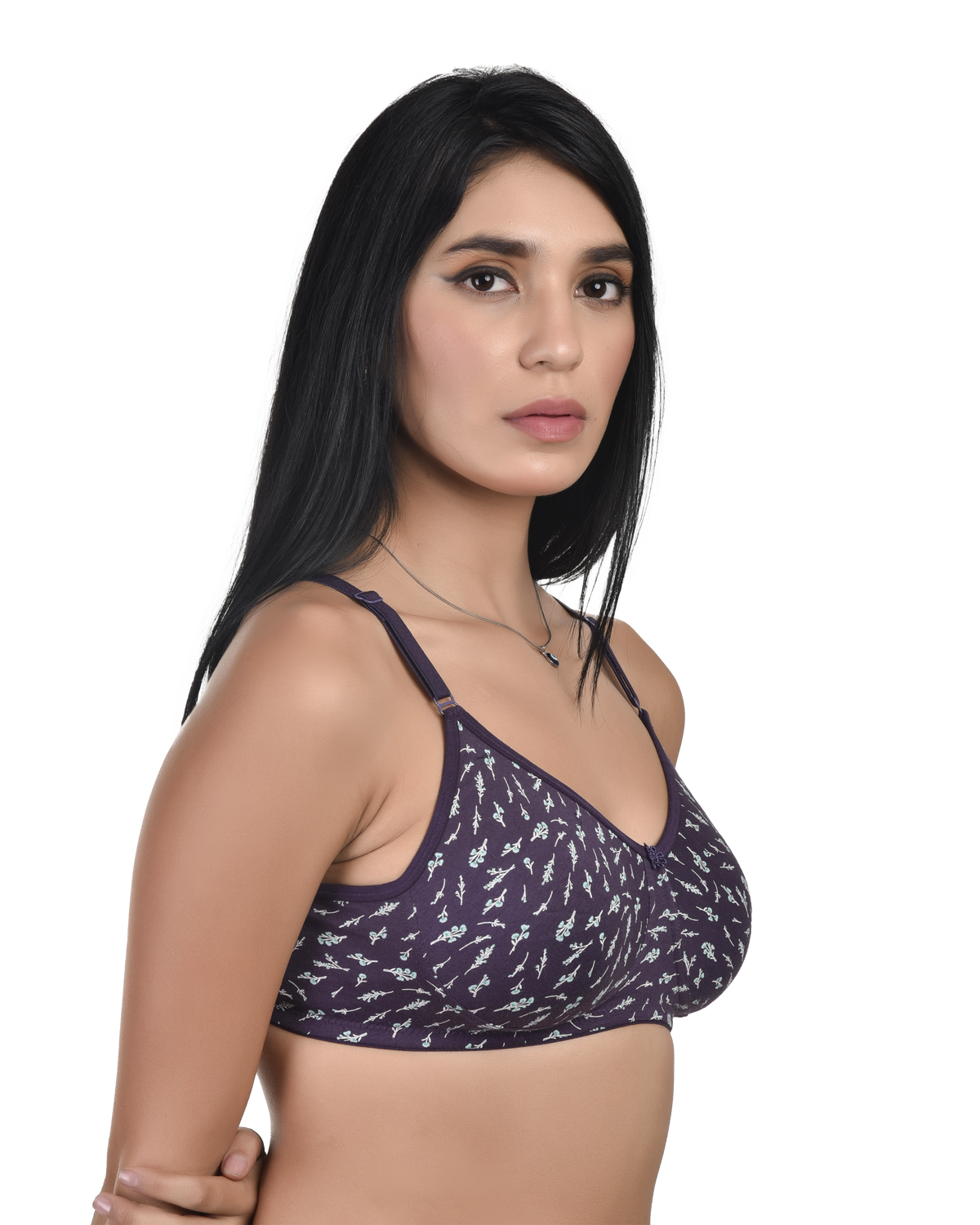 Woman wearing a purple patterned bralette on a white background
