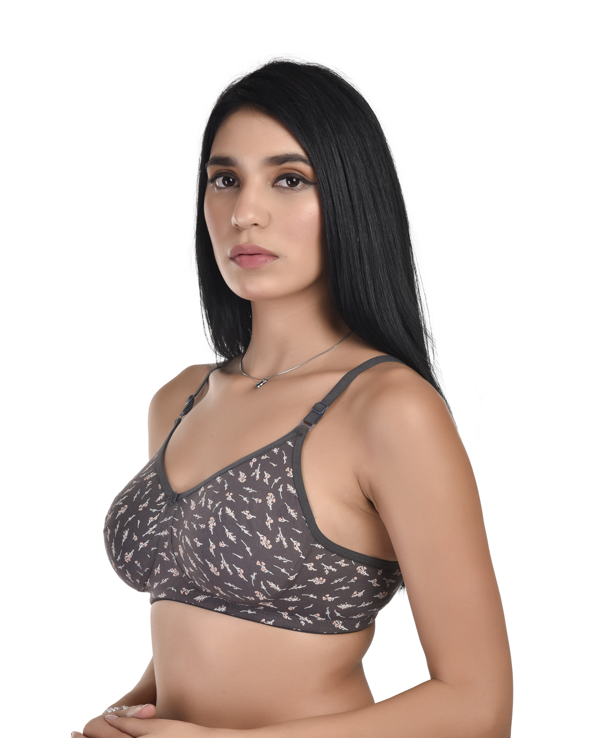 Woman wearing a gray patterned bralette on a white background