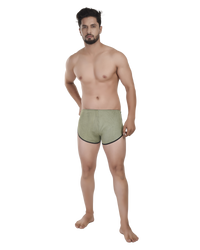 Man wearing green boxer briefs on a white background