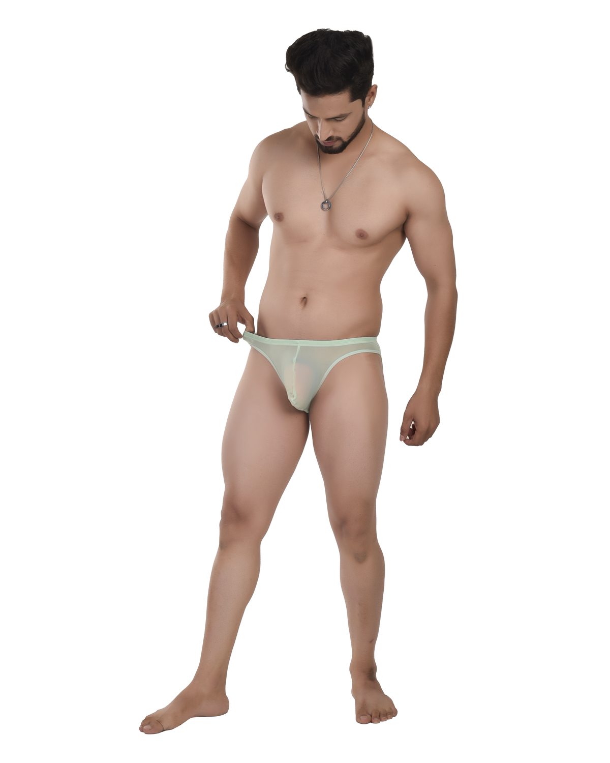Man wearing a light green thong on a white background
