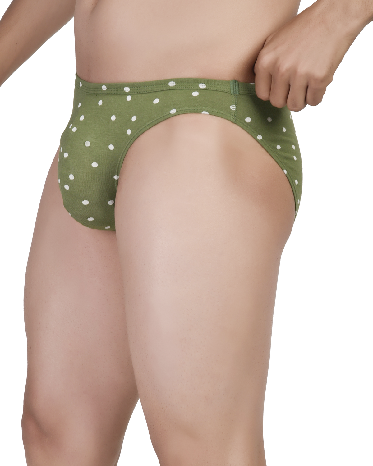 Green polka dot underwear worn by a person on a white background