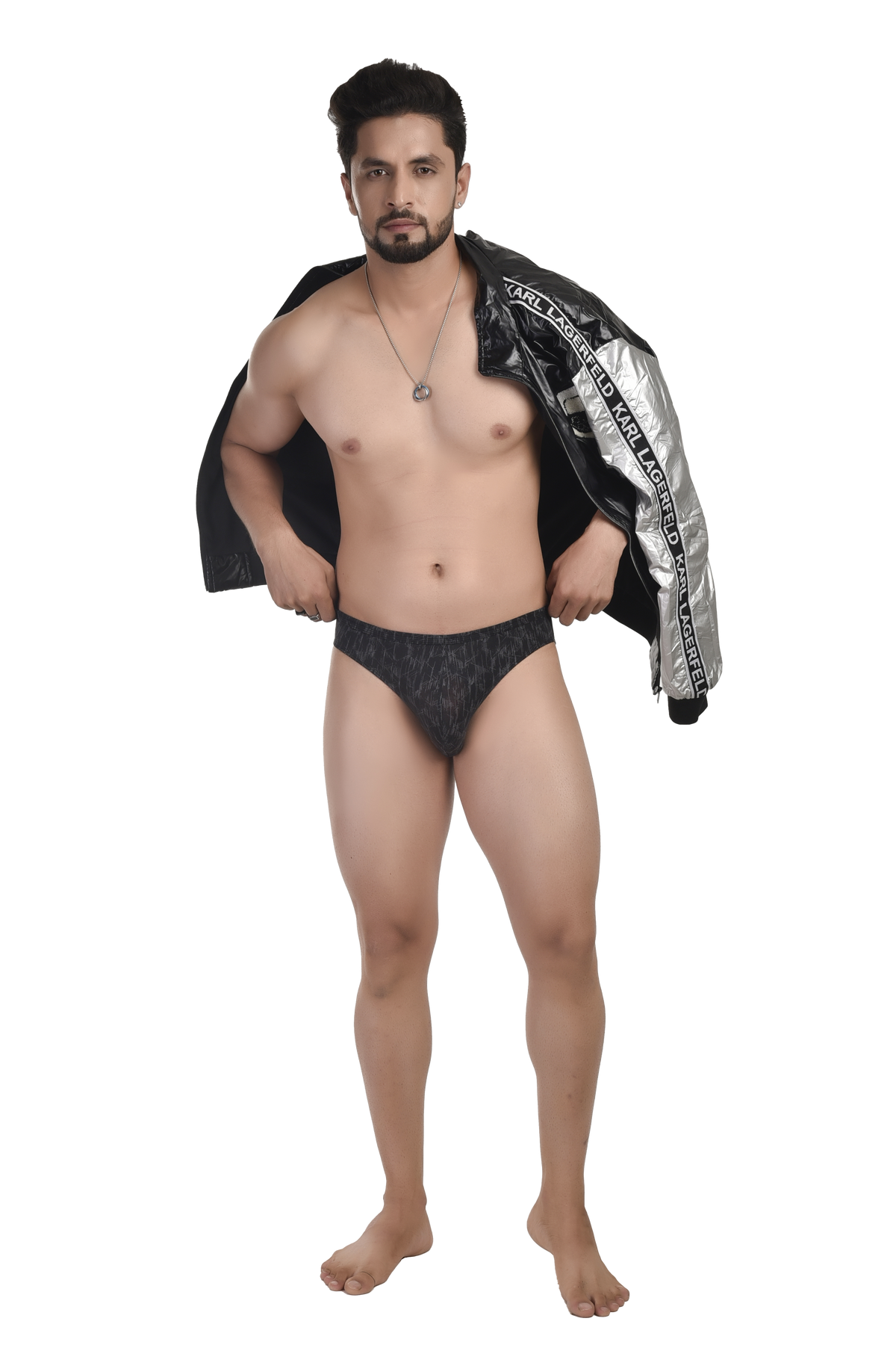 Man wearing black underwear with a jacket draped over his shoulders on a white background
