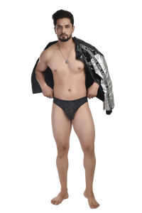 Man wearing black underwear with a jacket draped over his shoulders on a white background