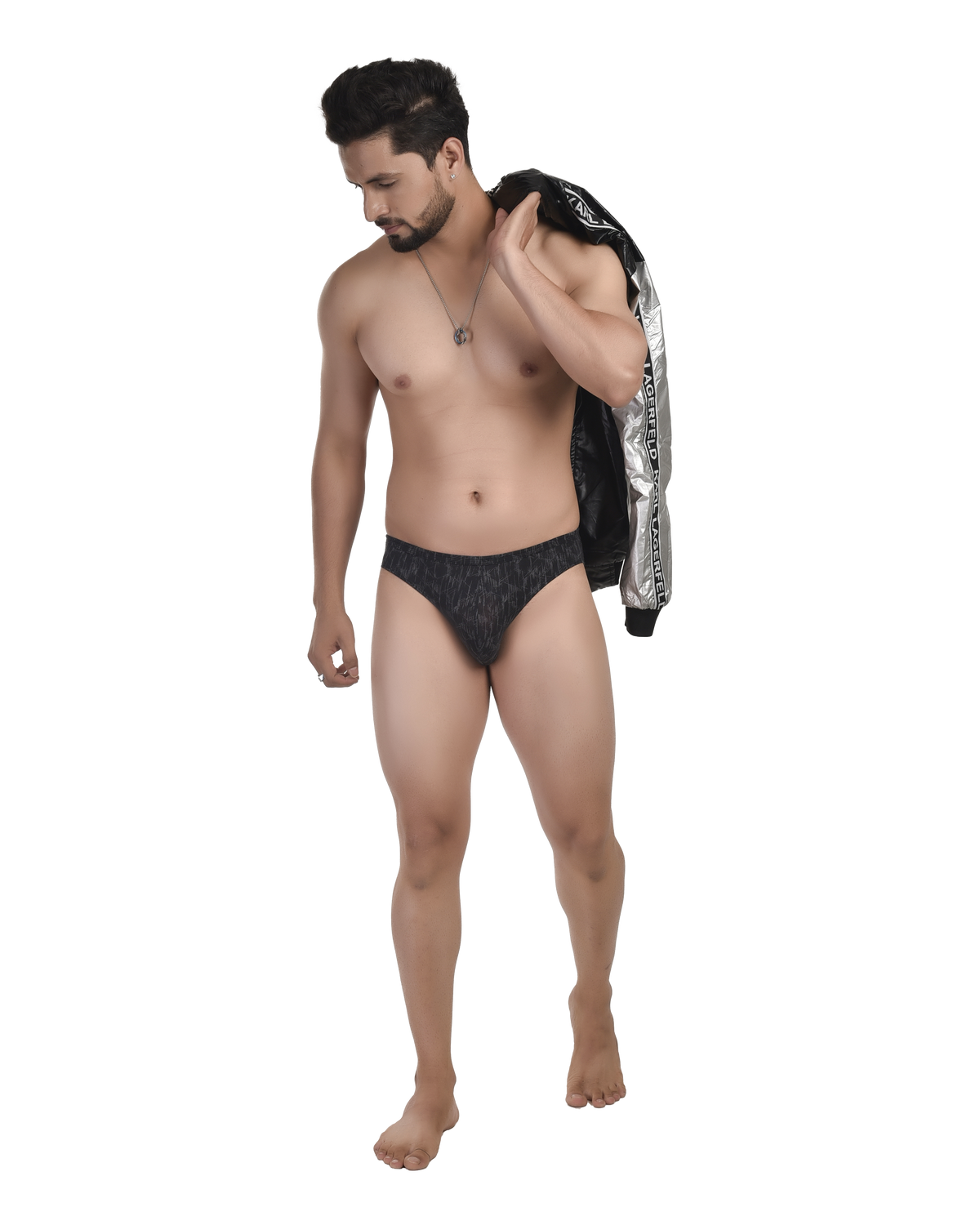 Man wearing black underwear with a jacket over his shoulder on a white background