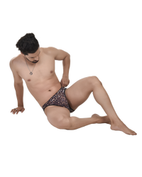 Man sitting on a white background wearing patterned underwear
