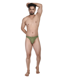 Man wearing green polka dot underwear on a white background