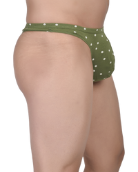 Green polka dot bikini bottom on a white background